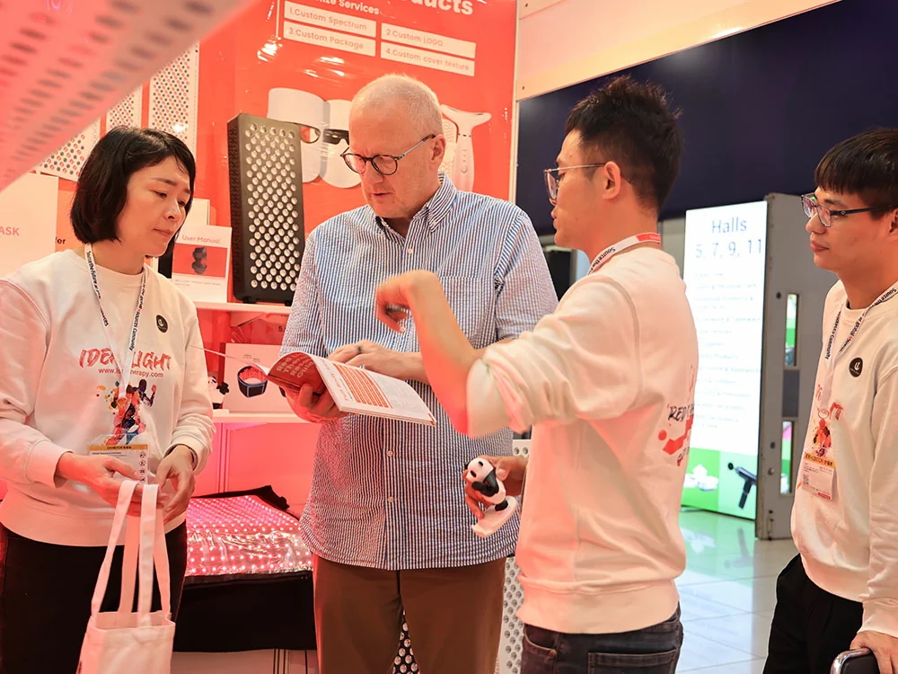 Exhibition team demonstrating product to visitor